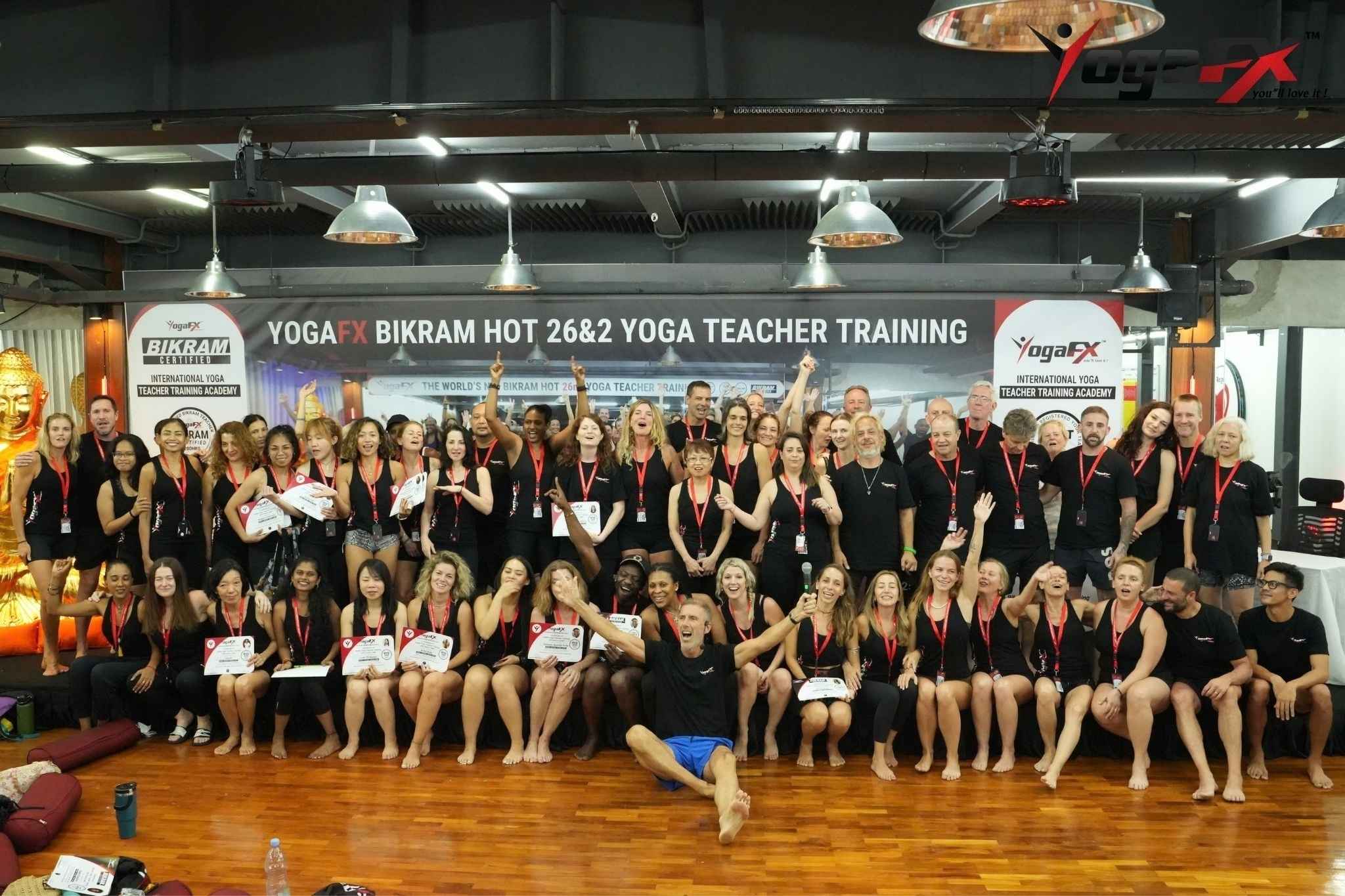 YogaFX Bikram Hot 26 and 2 teacher training graduates of many ages holding their certificates in Bali after the six-day intensive